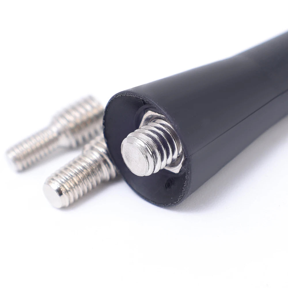 A close-up view of a black universal car roof antenna with threaded mounting screws.
