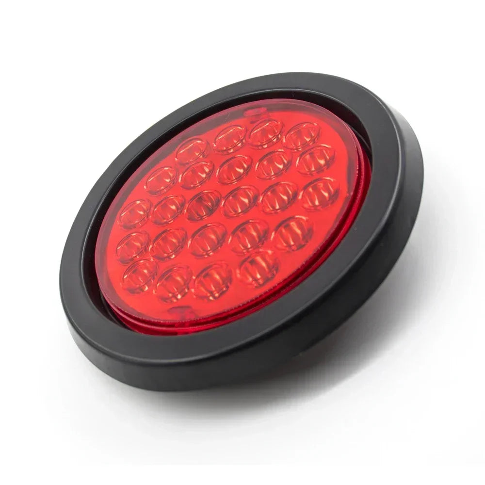 A round red LED trailer tail light with brake and turn signal mounted in a black housing.