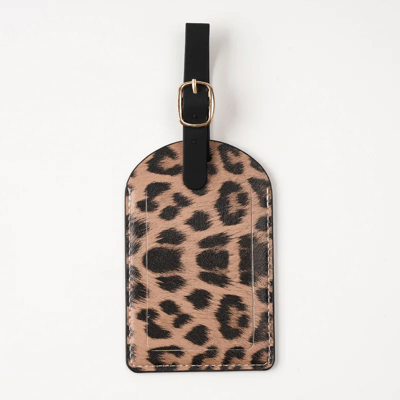 A black leather passport holder with card slots featuring a leopard print design.