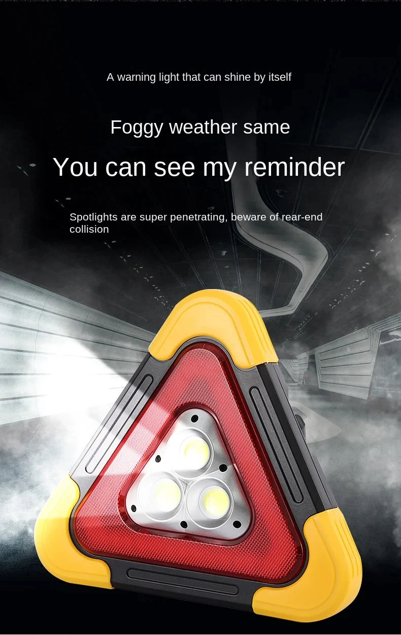 A triangular warning light with a red lens and yellow casing is shown against a dark background.
