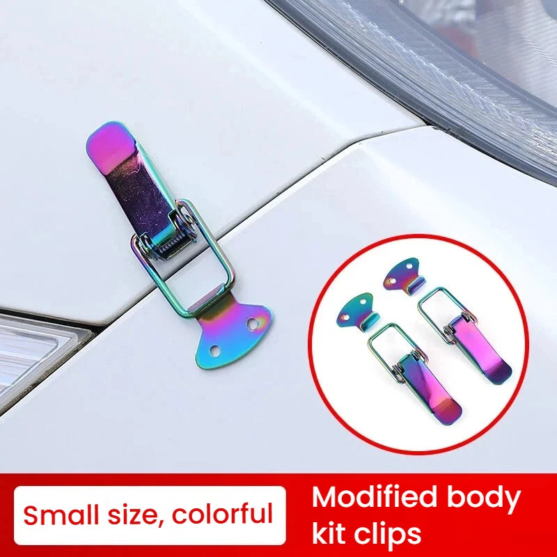 A close-up of modified body kit clips used as latch pins for a car hood or bonnet, showing colorful metal components.