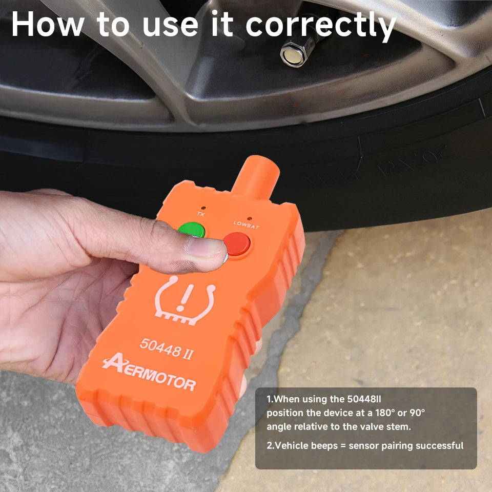 An orange electronic tool is shown being used to adjust a tire pressure sensor on a wheel rim.