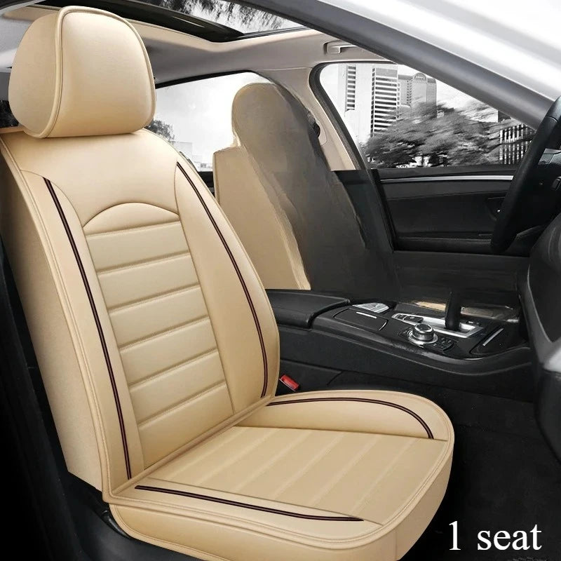 Interior view of a beige leather car seat with black piping and covers in a vehicle cabin.