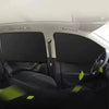 Interior view of a car showing two magnetic sun shades covering the rear windows.