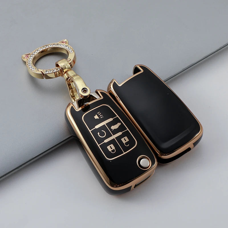 Gold-toned key fob with a clear ring and a black TPU case featuring buttons for vehicle functions.