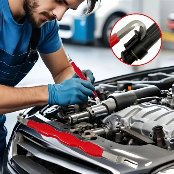 A person uses a red electrical connector disconnect tool on a car engine component.
