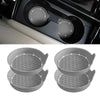 Un juego de tres posavasos decorativos de cristal y pedrería gris para vasos de coche, vistos desde varios ángulos.
