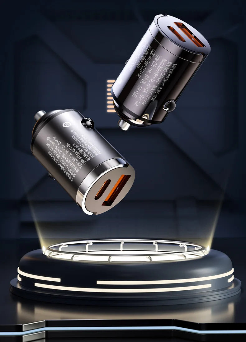 A close-up view of a silver dual port car charger with an LED light illuminating a circular base.