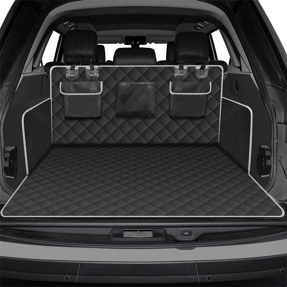 Interior view of a car trunk with a black quilted liner and padded pet seats.
