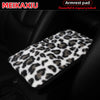 Leopard print plush cover for a car armrest.