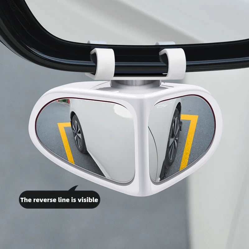 A white 360° adjustable blind spot mirror is mounted on a vehicle, showing the rear view with a visible yellow reverse line.