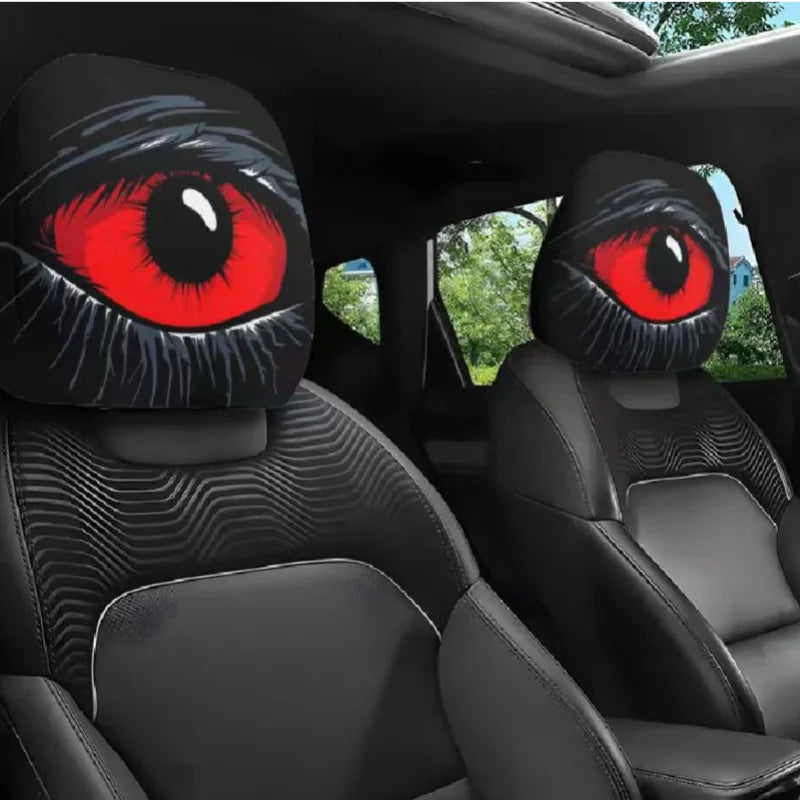 A pair of Halloween horror face car headrest covers featuring realistic red eyes on black fabric.