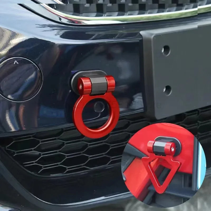 Close-up of a car trailer hook decal set featuring red and black components on a dark blue vehicle grille.