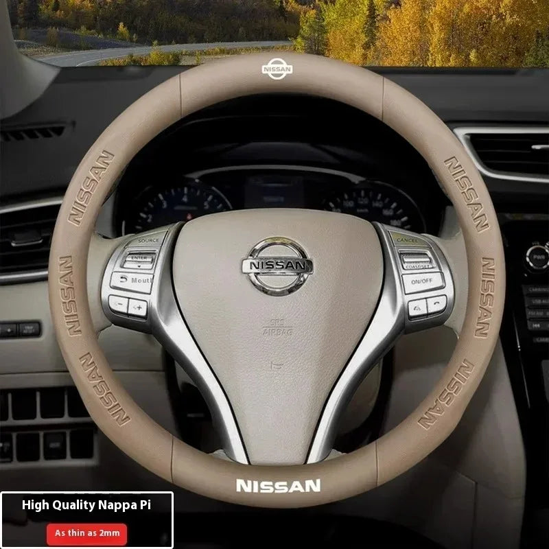 A close-up view of a beige Nissan steering wheel cover with Nissan branding and controls.