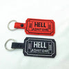 Two gothic keyfob luggage tags, one red and one black, featuring the name HELL and the number 666.