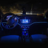 Interior view of a car dashboard showing ambient LED lighting and controls.