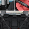 Black genuine leather seat belt protector covers installed in a car interior.