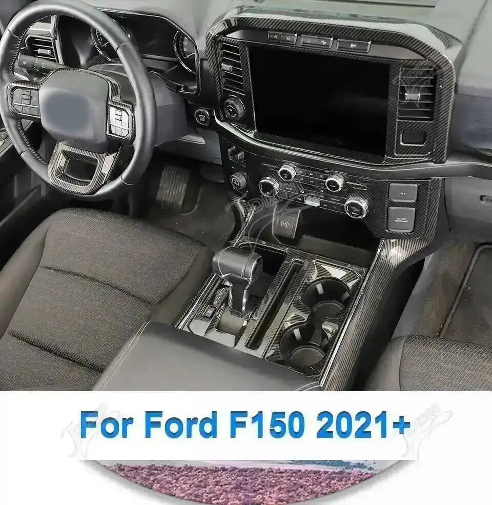 Carbon fiber grain interior trim kit for a Ford F150 showing the dashboard and steering wheel area.