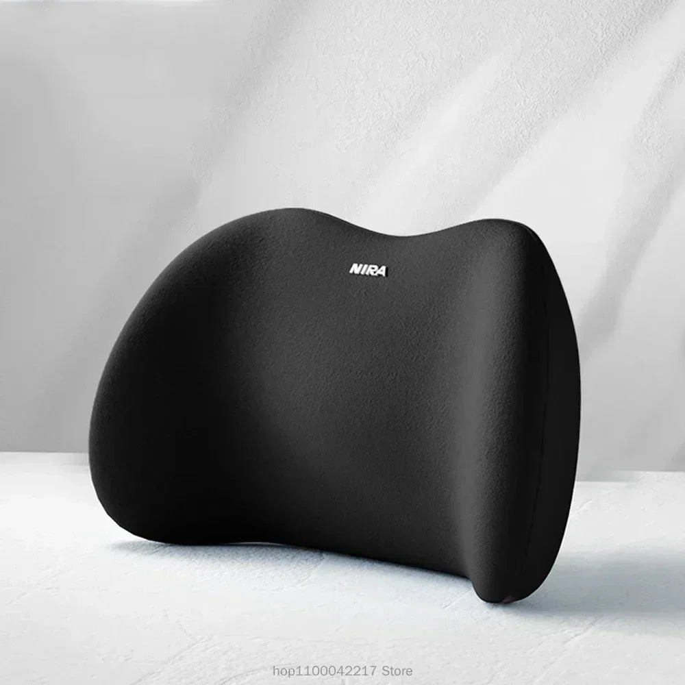 A black universal car headrest neck support pillow resting on a white surface.