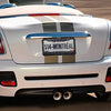 A white car with a diamond rhinestone license plate frame displaying the text 514 MONTREAL.