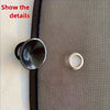 A close-up photo showing two metal sunshade components, including a circular disc and a ring, against a gray textured surface
