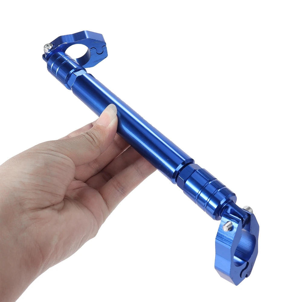 A hand is holding a blue adjustable motorcycle handlebar grip crossbar.