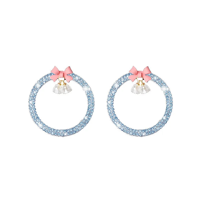 Pair of decorative rhinestone bow bell car start switch button trim in light blue and pink.