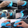 Hands cleaning a car dashboard vent with blue reusable gel and cloth.