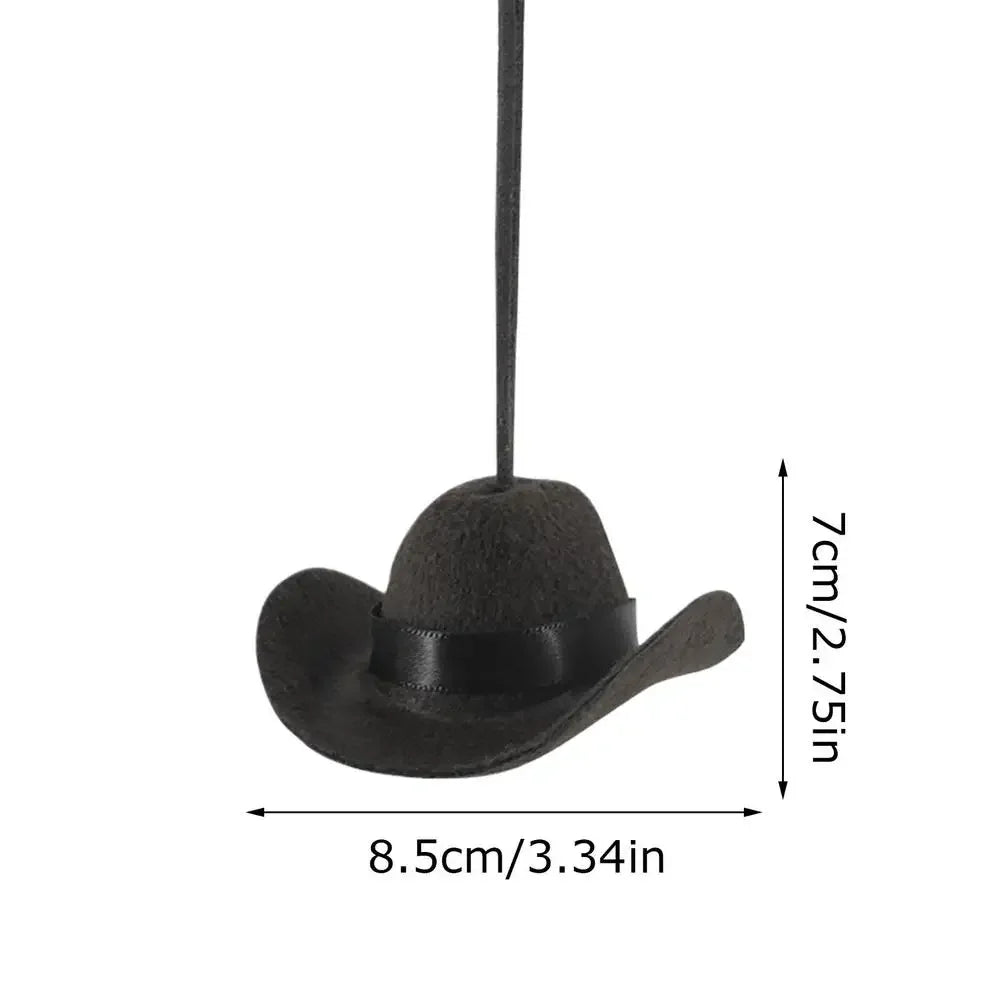 Black fabric cowboy hat ornament hanging on a string