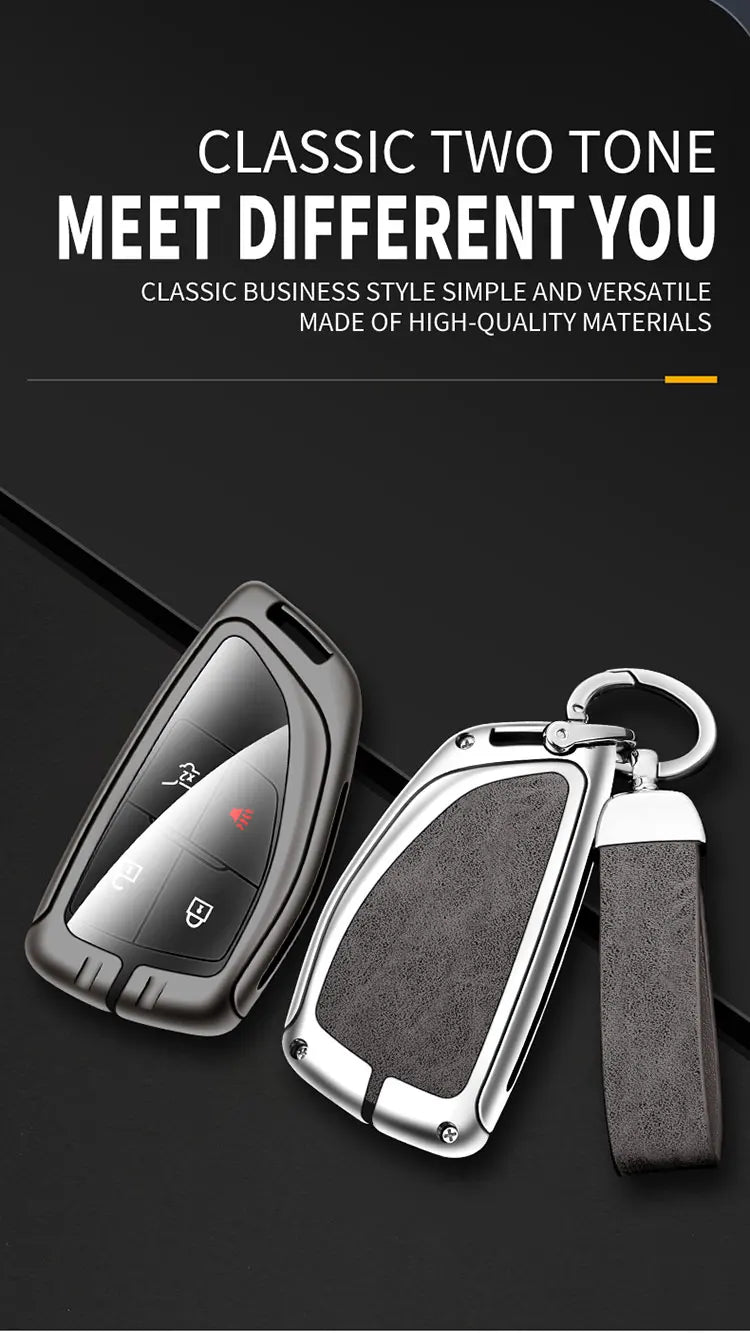 A black durable zinc alloy car key case with a silver keyring and black strap is shown on a dark background.