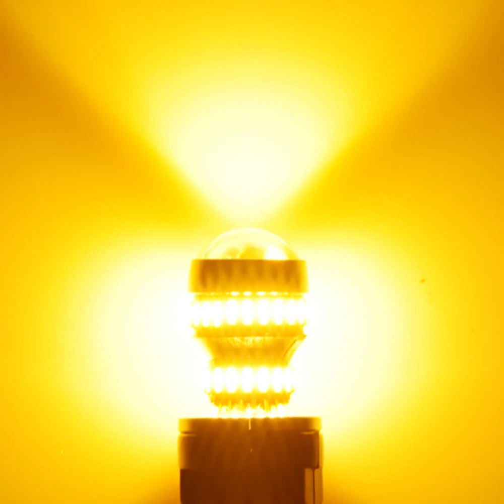A bright yellow universal LED bulb set illuminating a vehicle light.