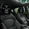 A pair of black portrait print car headrest covers featuring skull designs on a car seat interior.