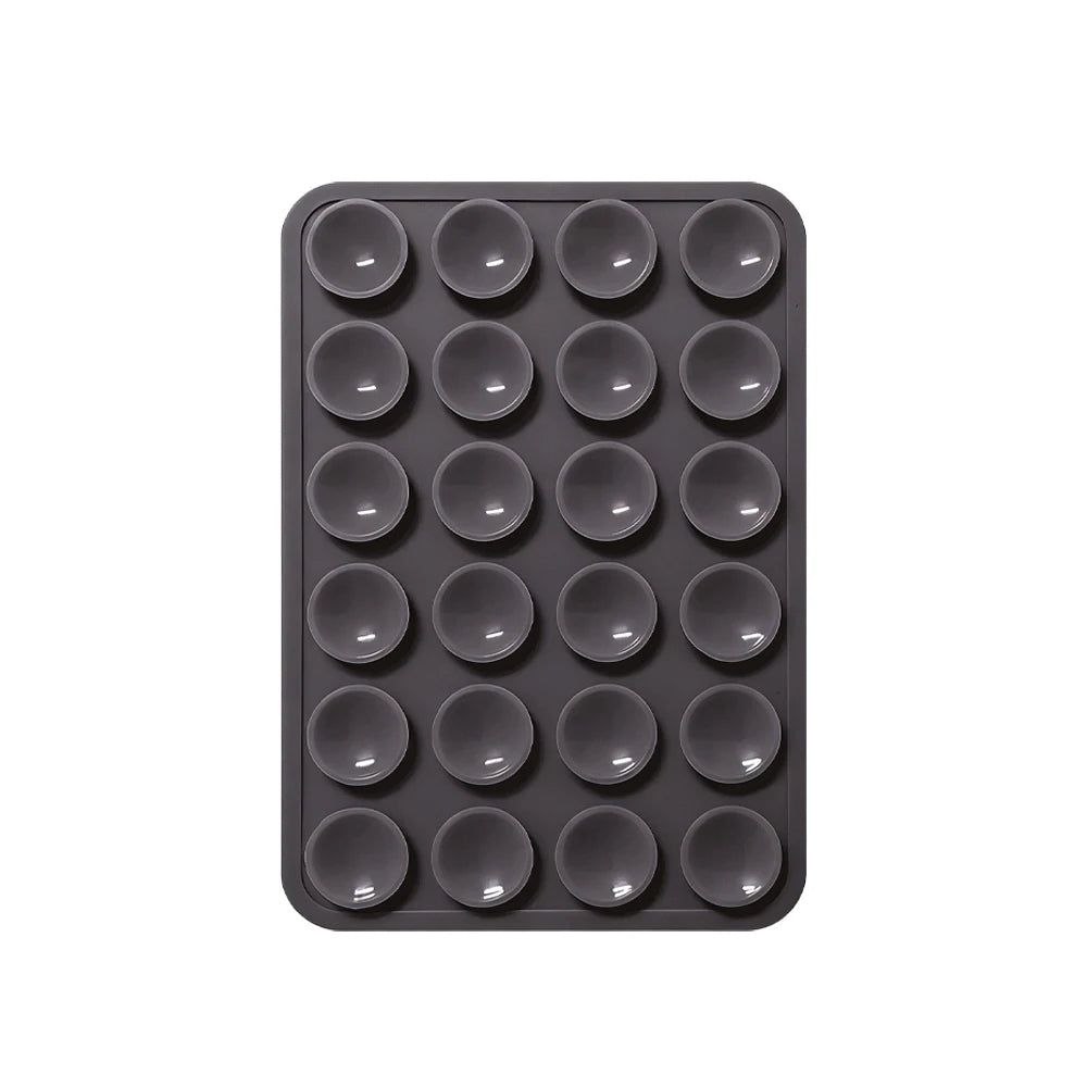 Schwarze Silikon-Saugnapf-Handyhalterung mit mehreren kreisförmigen Löchern zum Befestigen von Geräten.