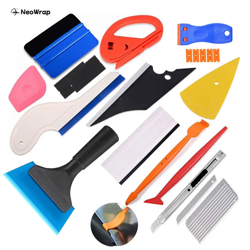 A collection of professional window tinting and vinyl wrapping tools including various blades, scrapers, and cutters.