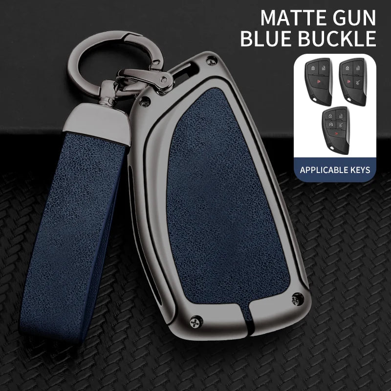 A matte gun blue buckle car key case with a silver finish and a dark blue strap, shown next to applicable keys.