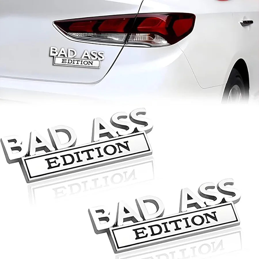 A close-up of a red taillight with a Bad Ass Edition logo decal applied to the exterior of a white car.