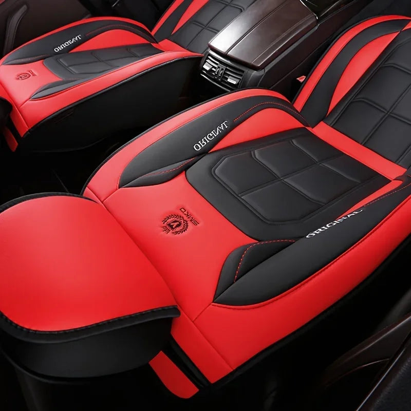 Red and black leather car seat covers showing a driver's seat interior detail.
