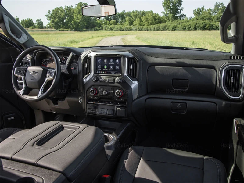 Interior view of a truck dashboard showing the steering wheel, infotainment screen, and controls.