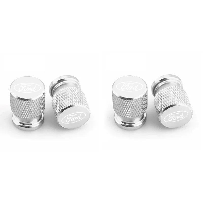 Three silver aluminum Ford car wheel valve caps shown side by side