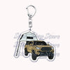 Silver acrylic keychain featuring a detailed model of a yellow off-road truck.