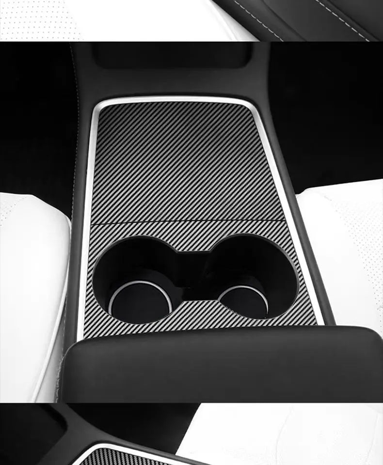 Interior view of a car dashboard featuring a black and white patterned cover.