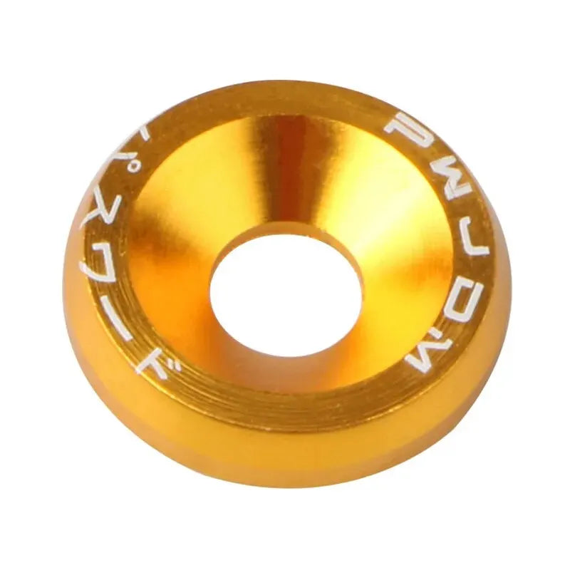 A brass-colored aluminum fender washer or bolt from an M6 car fastener kit.