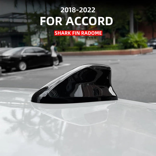 Black shark fin roof antenna cover installed on a white Honda Accord car.