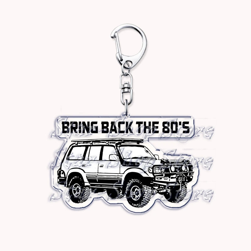 Silver acrylic keychain featuring a white off-road truck.