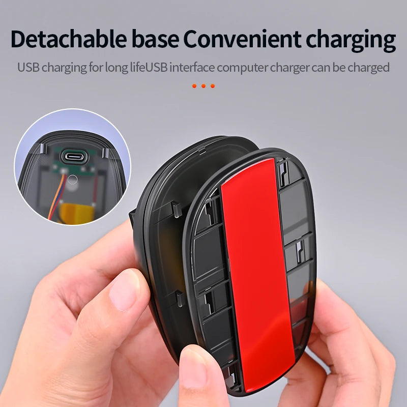 A hand holds a black detachable base charger for a USB interface computer charger with a red component visible.