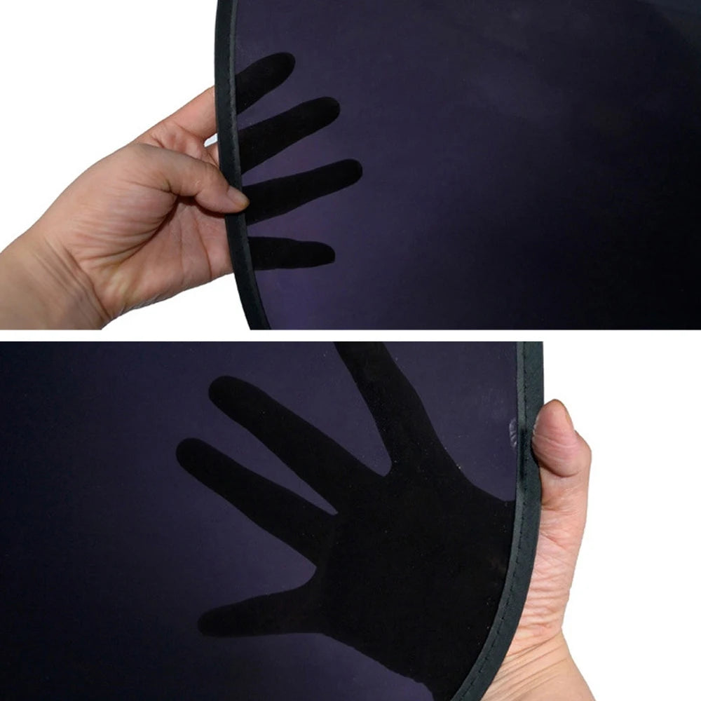 A hand is holding a dark purple sun shade, showing the silhouette of a hand pressed against the fabric.