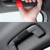 A hand grips a black and red handle cover installed on a car roof, showing the upgrade to a SPORT style.