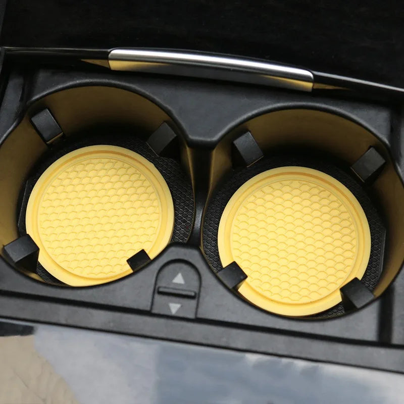 A set of decorative rhinestone car coasters in yellow and black are shown inside a black box.