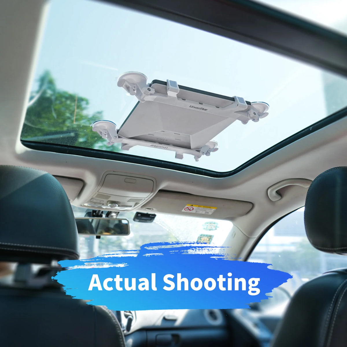 A portable suction mount for Starlink Mini devices is installed on a car's windshield.