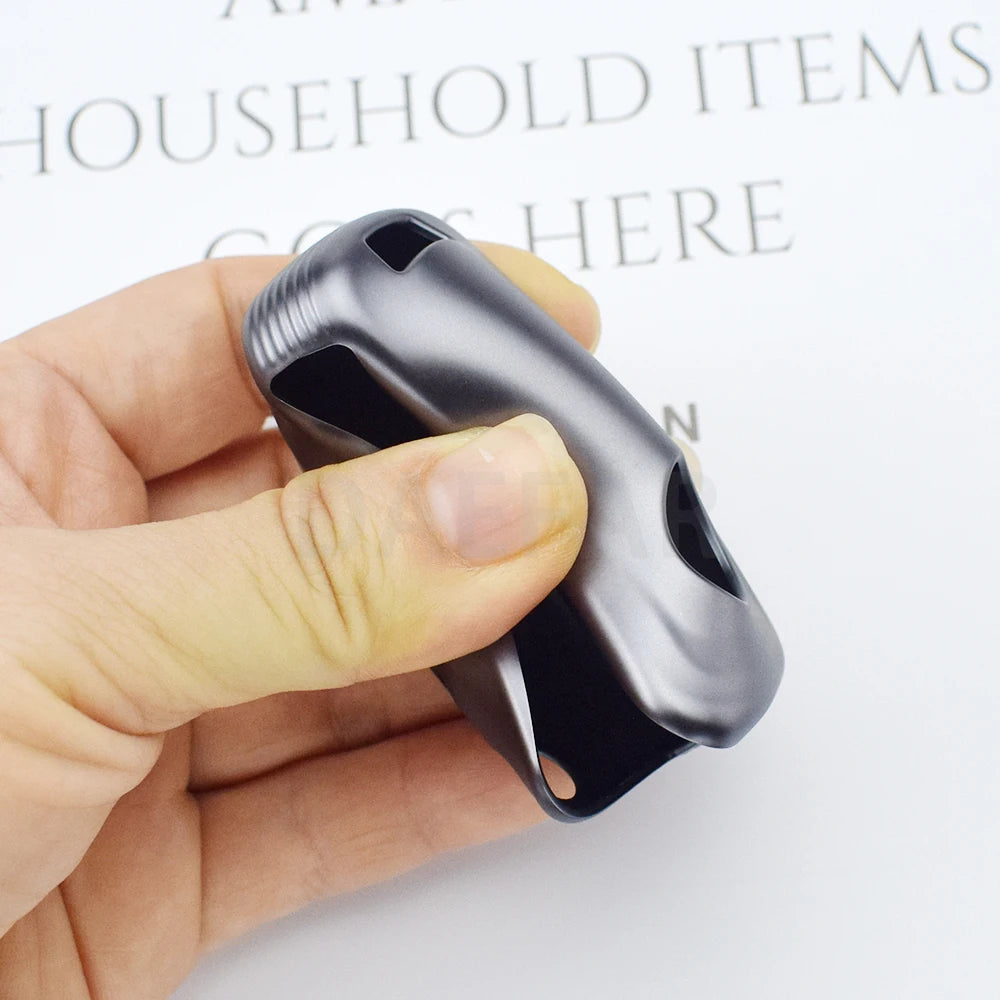 A hand holds a black universal car key cover for Chevrolet, Buick, Opel, Astra, and more.